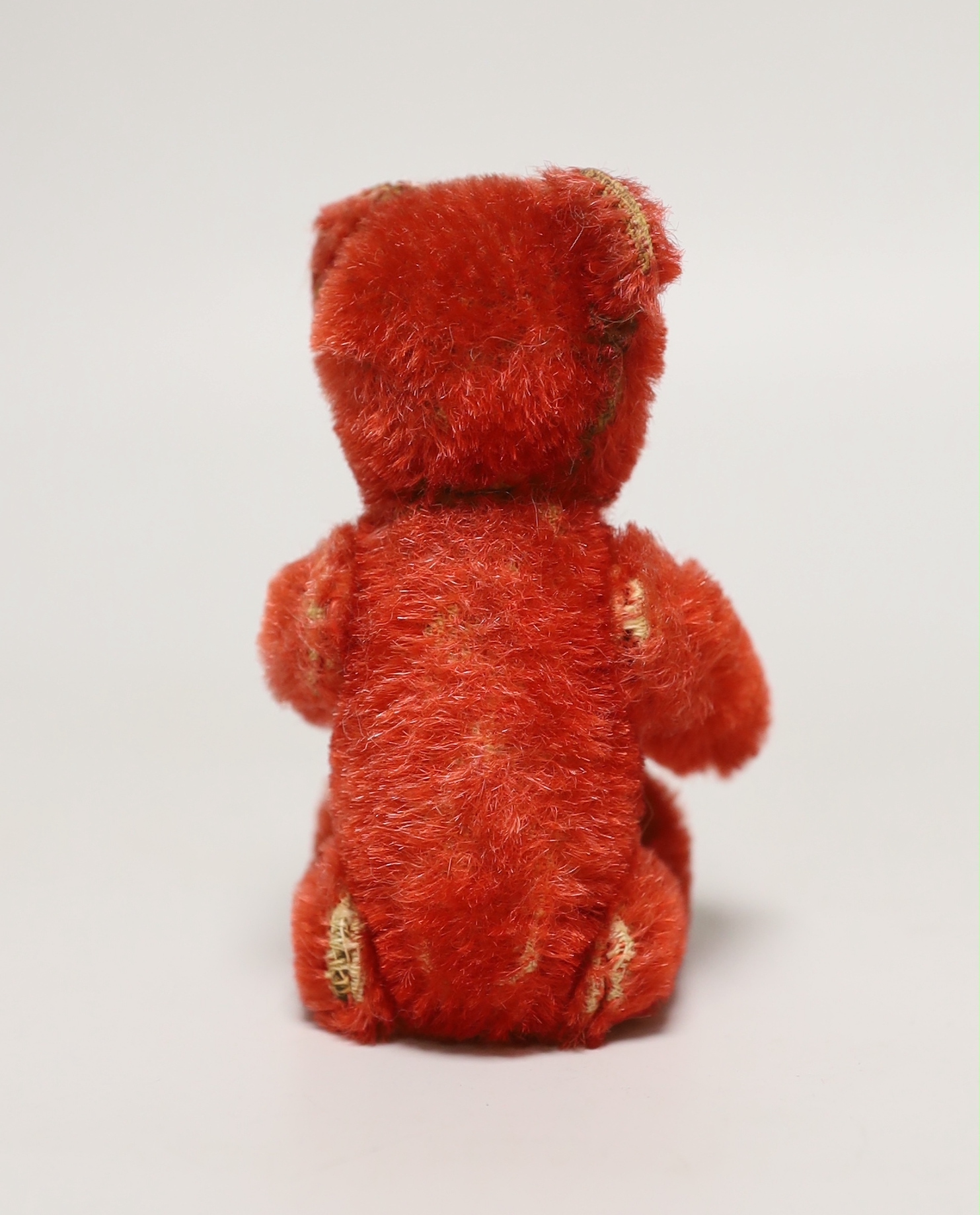 A red Schuco perfume bear, c.1920s, 5in., in excellent condition, missing stopper